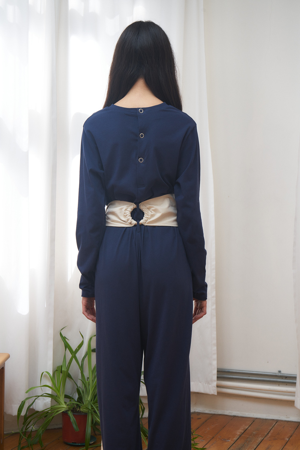 ahu jumpsuit dark blue jersey fabric with push-button closure on the backside.