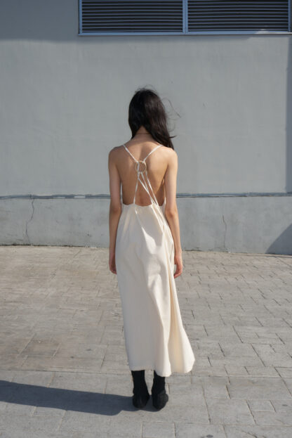 Eba halter dress open back and tie-strings around a small wooden ring.