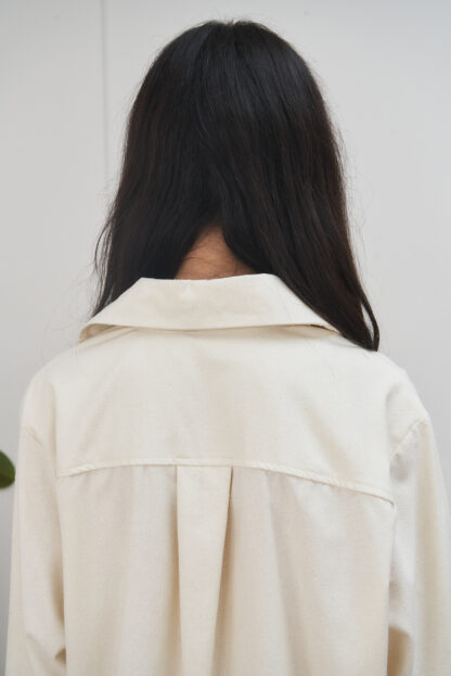 raw silk shirt with front pocket and long sleeves. unbleached ecru color. backside details.